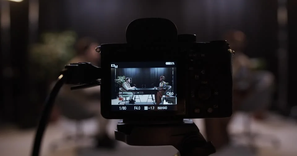 Illustrative podcast production behind a broadcast graphics concept